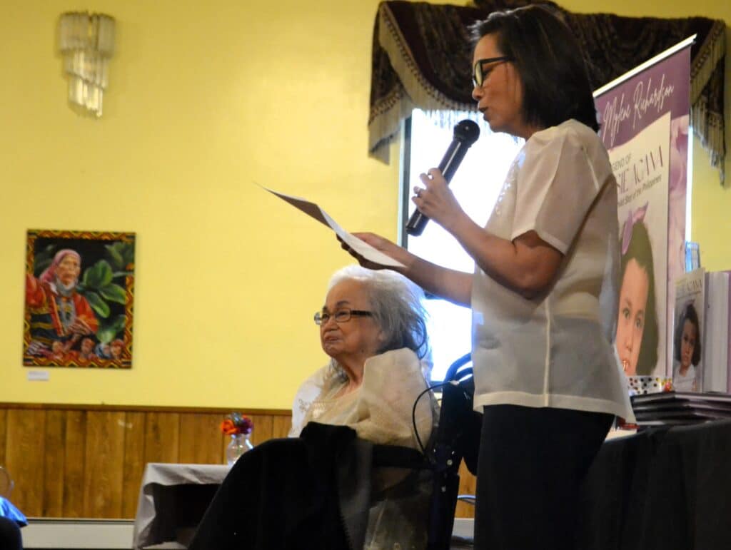 Mylene Richardson reading with Tessie Agana looking on